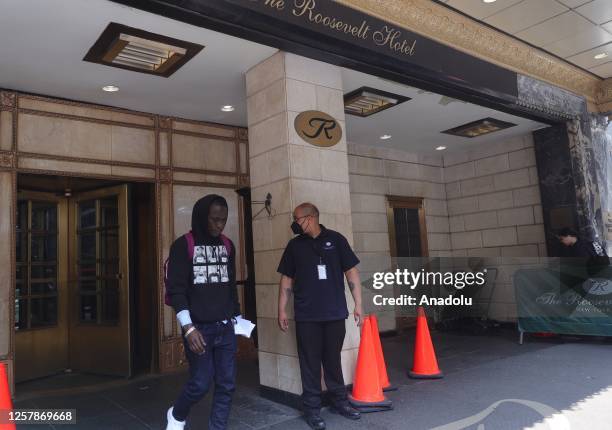 An asylum seeker leaves New York's iconic Roosevelt Hotel in midtown Manhattan which reopens as shelter for asylum seekers in New York City, United...