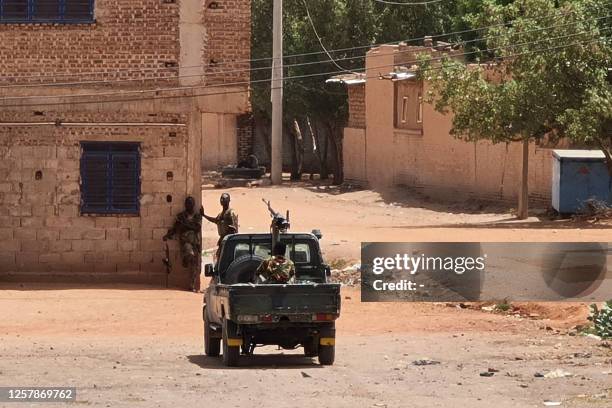 Sudanese army soldiers rest next to a building in Khartoum on May 25 Fighting eased in Sudan, the second full day of a ceasefire that has allowed...