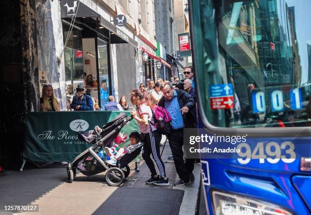 An immigrant family is seen in front of New York's iconic Roosevelt Hotel in midtown Manhattan which reopens as shelter for asylum seekers in New...