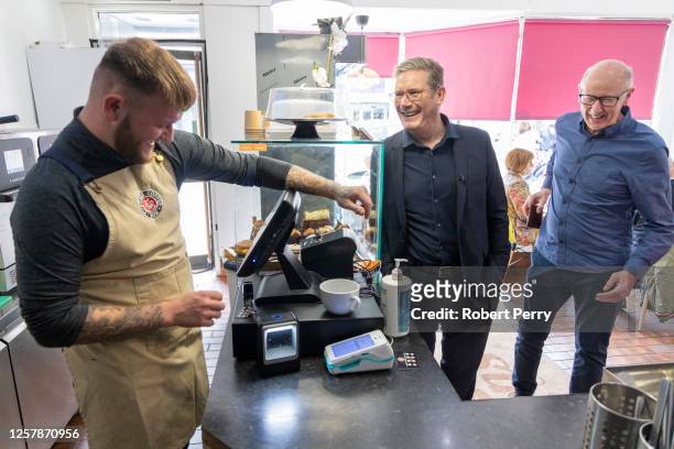 Keir Starmer meets local coffee shop owner Brandon Lowe during a visit to local high street businesses on May 25, 2023 in Kirkcaldy, Scotland. Keir...