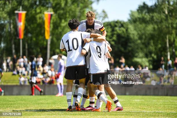 Jamie Schuldes of Germany jumps and celebrates with Franz Bleicher of Germany and Taycan Etcibasi of Germany after a goal was scored by Cenny Neumann...