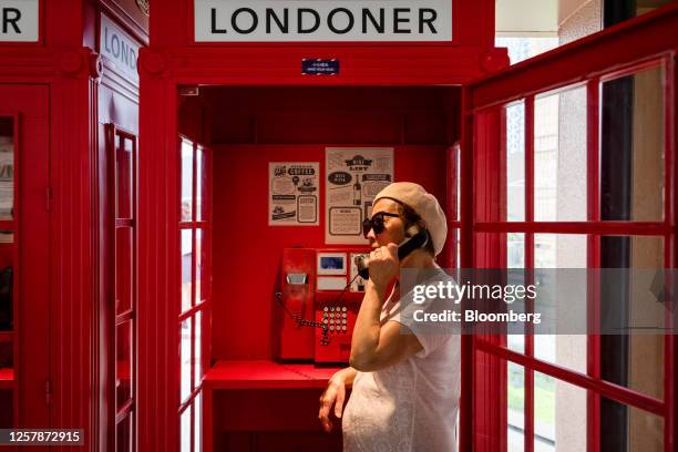 Visitors talks on a red phone booth at the Londoner Macao casino resort, operated by Sands China Ltd., a unit of Las Vegas Sands Corp., in Macau,...