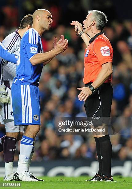 Alex of Chelsea argues with referee Chris Foy as he is sent off during the Carling Cup Third Round match between Chelsea and Fulham at Stamford...