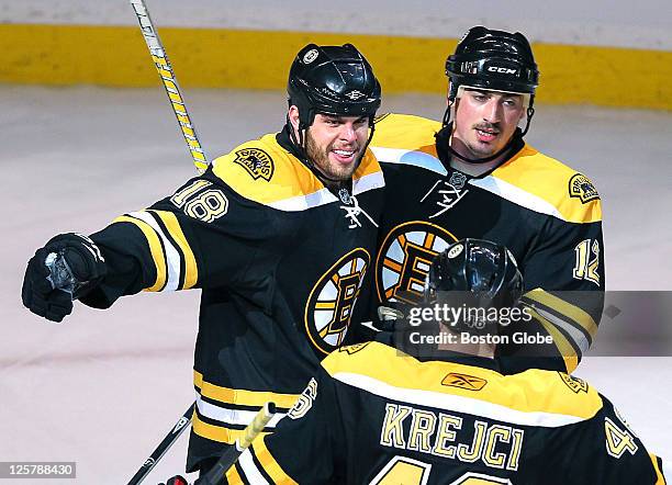 Game Three of the Eastern Conference semi-finals, Bruins Nathan Horton, left, celebrates with Tomas Kaberle, right, and David Krejci his 2nd period...