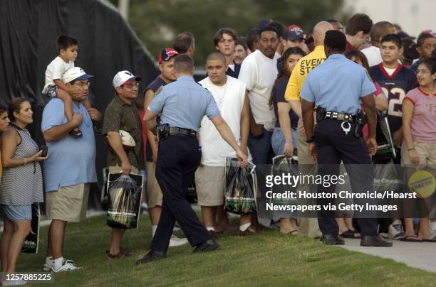 Houston Police officers try to control an overflow crowd during the first public practice of the Houston Texans inaugural training camp, Monday...