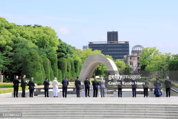 Leaders of guest nations and international organizations invited to the Group of Seven summit in Hiroshima offer flowers at the cenotaph for atomic...