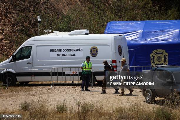 Portuguese Judicial Police criminal investigation unit members are seen near the Arade dam in Silves on May 25 after the search operation in the...