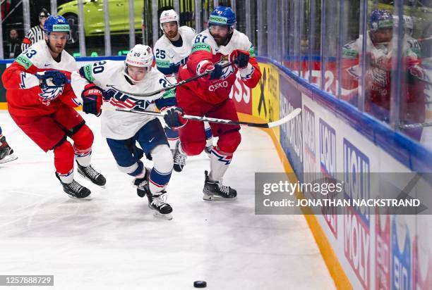 S defender Lane Hutson and Czech Republic's forward Martin Kaut vie during the IIHF Ice Hockey Men's World Championships quarter final match between...