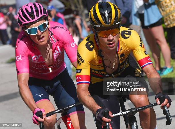 Overall leader's pink jersey, INEOS Grenadiers's British rider Geraint Thomas and Jumbo-Visma's Slovenian rider Primoz Roglic ride during the...