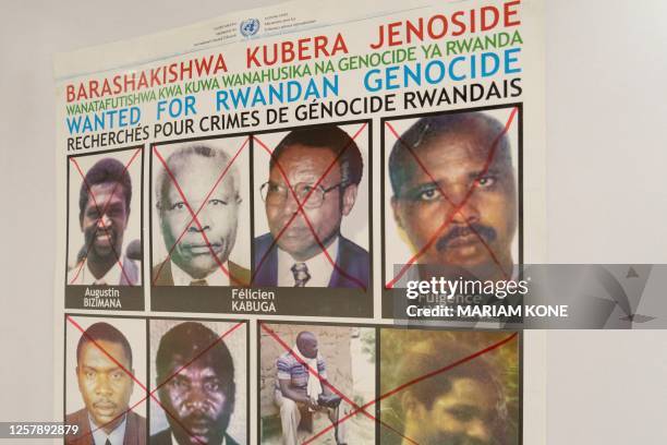 Fulgence Kayishema is seen on a wanted poster on the wall at the Genocide Fugitive Tracking Unit office, in Gishushu, in Kigali on May 25, 2023....