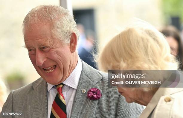 Britain's King Charles III and Britain's Queen Camilla react during a visit to Enniskillen Castle, on May 25, 2023 as part of a two-day visit to...