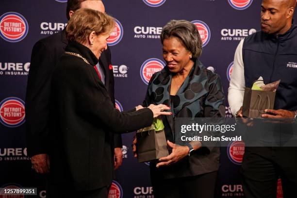 Sportscaster, George Blaha, and his wife, Mary Blaha gift Jaden Ivey of the Detroit Pistons, his mother Niele Ivey, his father, Javin Hunter a...