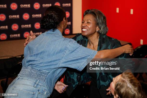 Sportscaster, George Blaha, and his wife, Mary Blaha gift Jaden Ivey of the Detroit Pistons, his mother Niele Ivey, his father, Javin Hunter a...