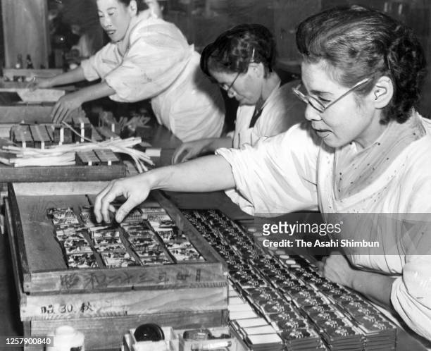 Workers produce 'Hanafuda' Japanese playing cards at Nintendo's factory on November 29, 1956 in Kyoto, Japan.
