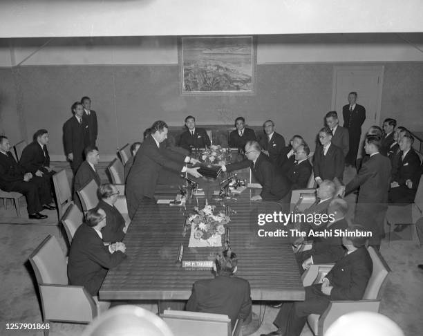 Soviet Union Deputy Foreign Minister Nikolai Fedorenko and Japanese Foreign Minister Mamoru Shigemitsu exchange the documents as the Soviet-Japanese...