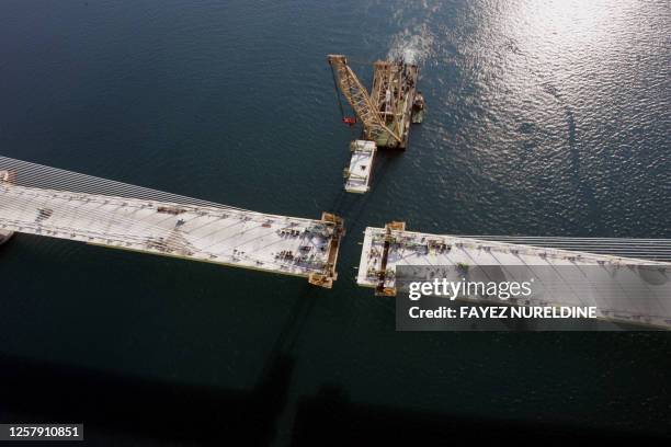 An aerial view shows the final piece of Greece's Rio-Antirio bridge, is put into place some 50 metres above sea level, completing basic construction...