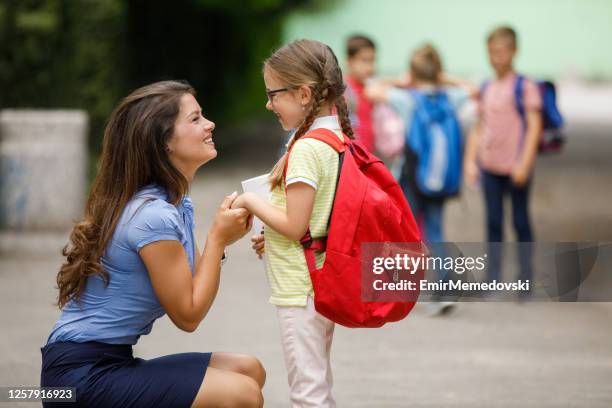 mother sending her daughter to school - first day school hug stock pictures, royalty-free photos & images