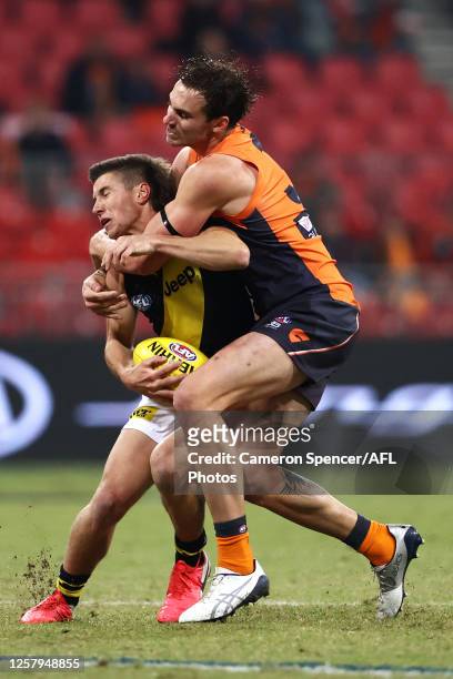 Jeremy Finlayson of the Giants tackles Liam Baker of the Tigers during the round 8 AFL match between the Greater Western Sydney Giants and the...