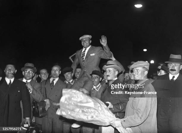 Haltérophile Louis Hostin, médaillé d'or olympique, est porté en triomphe à son arrivée à la gare du Nord, à Paris, France le 8 août 1936.