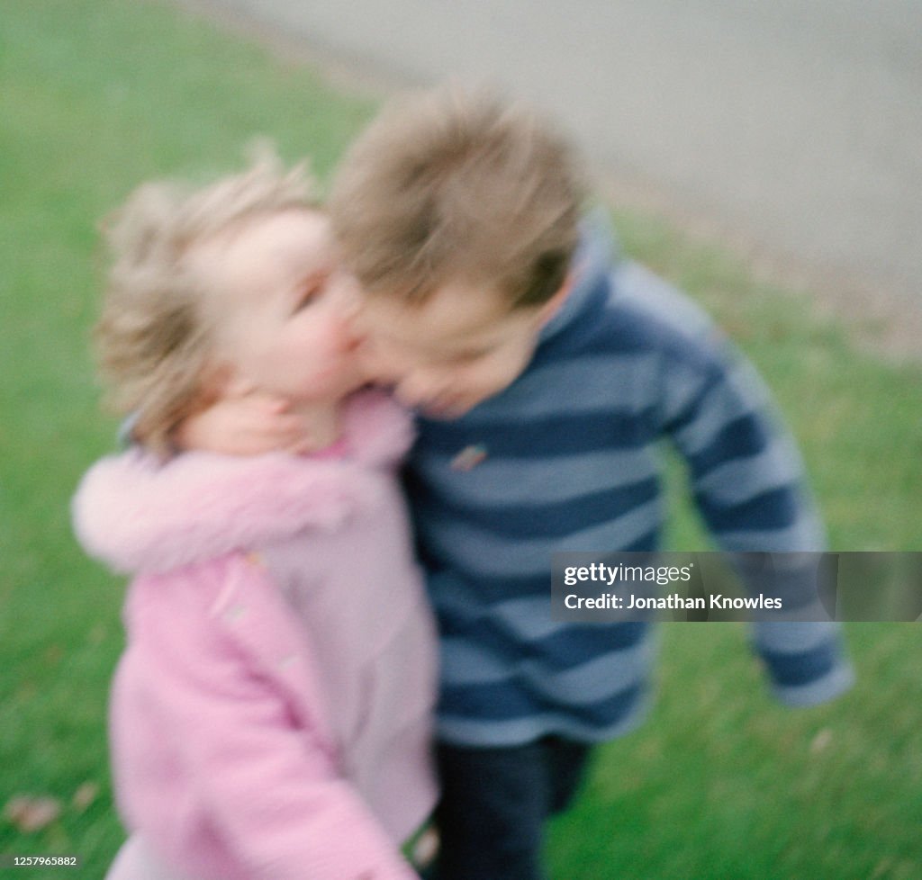 Brother and sister hugging