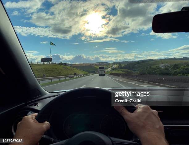 point of view of a man driver on the highway - point of view driving stock-fotos und bilder
