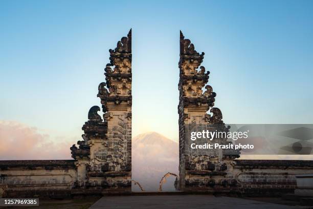 temple gates of heaven and mount agung is famous destination to sightseeing during sunrise in morning at lempuyang luhur temple in bali, indonesia. - gates of heaven bali stock-fotos und bilder