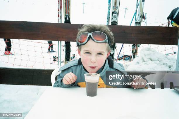 portrait boy with hot chocolate - apres ski stock pictures, royalty-free photos & images