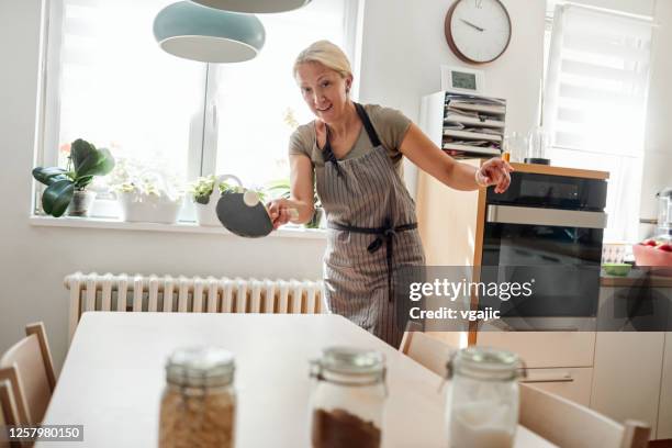 woman playing table tennis in the dining room - makeshift kitchen stock pictures, royalty-free photos & images