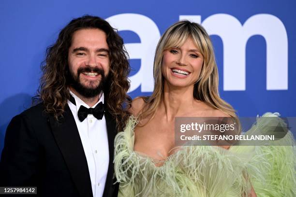 German musician Tom Kaulitz and German model Heidi Klum arrive to attend the annual amfAR Cinema Against AIDS Cannes Gala at the Hotel du...