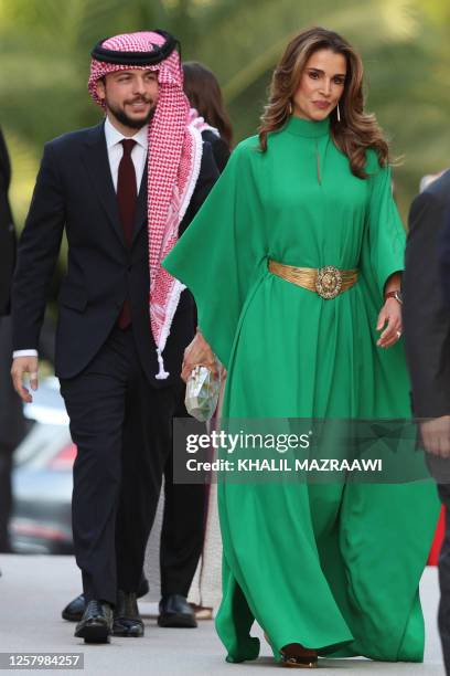 Jordan's Queen Rania and Crown Prince Hussein, arrive at the Raghdan Royal Palace in Amman, to attend an official event celebrating the 77th...