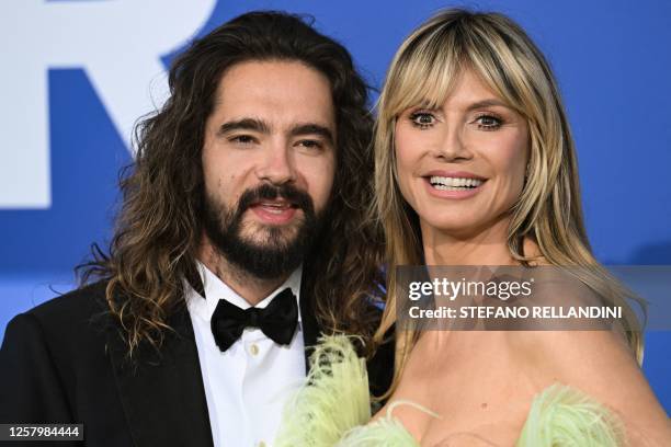 German model Heidi Klum and her husband German musician Tom Kaulitz arrive to attend the annual amfAR Cinema Against AIDS Cannes Gala at the Hotel du...