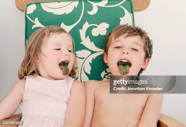 brother and sister with green tongues - candy on tongue stock pictures, royalty-free photos & images