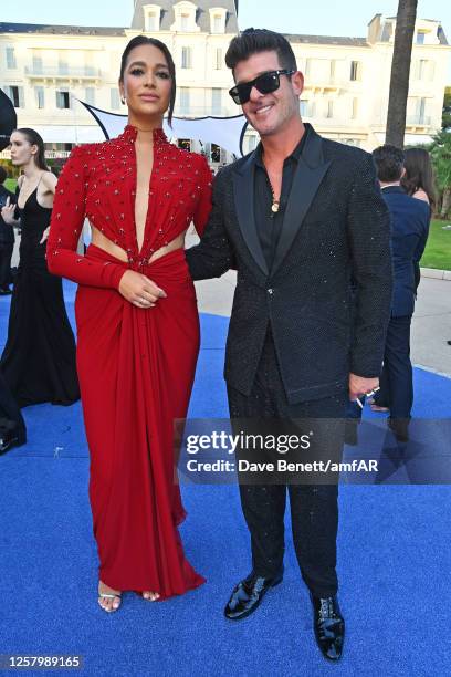 April Love Geary and Robin Thicke attend the amfAR Cannes Gala 2023 at Hotel du Cap-Eden-Roc on May 25, 2023 in Cap d'Antibes, France.