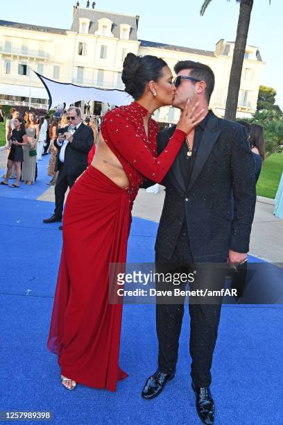 April Love Geary and Robin Thicke attend the amfAR Cannes Gala 2023 at Hotel du Cap-Eden-Roc on May 25, 2023 in Cap d'Antibes, France.