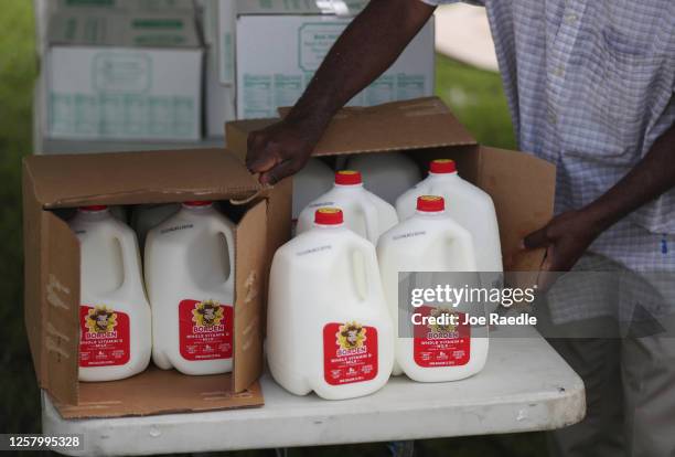 Gallons of milk are prepared to be given out at a drive-thru food distribution site set up at the First Church of the Brethren on July 24, 2020 in...