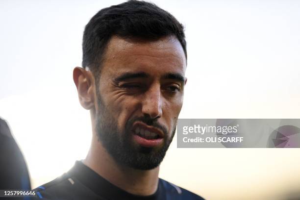 Manchester United's Portuguese midfielder Bruno Fernandes warms up ahead of the English Premier League football match between Manchester United and...