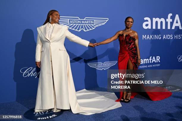 Rapper Queen Latifah and US choreographer Eboni Nichols arrive to attend the annual amfAR Cinema Against AIDS Cannes Gala at the Hotel du...