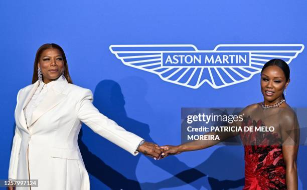 Rapper Queen Latifah and US choreographer Eboni Nichols arrive to attend the annual amfAR Cinema Against AIDS Cannes Gala at the Hotel du...