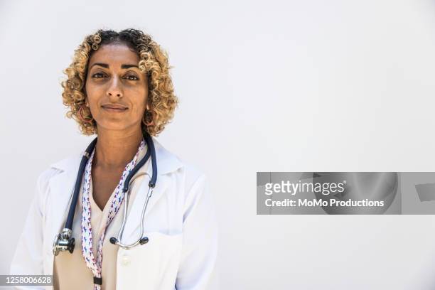 studio portrait of female doctor/healthcare worker - leanincollection healthcare stock pictures, royalty-free photos & images