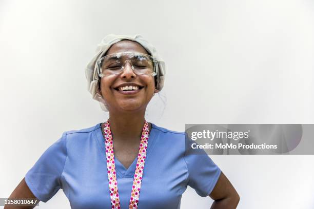 studio portrait of nurse - nurse and portrait and white background and smiling and female and looking at camera stock-fotos und bilder