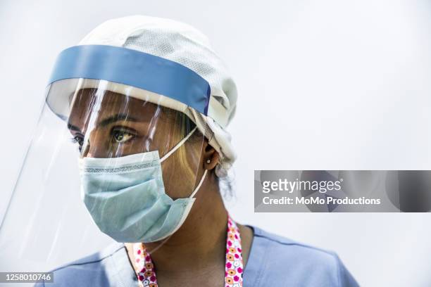 Studio portrait of nurse wearing faceshield and mask
