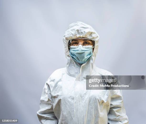 studio portrait of healthcare worker in biohazard suit - white suit stock pictures, royalty-free photos & images