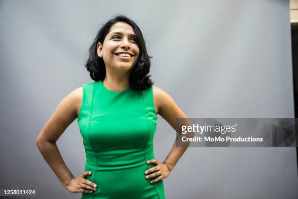studio portrait of businesswoman - green dress 個照片及圖片檔