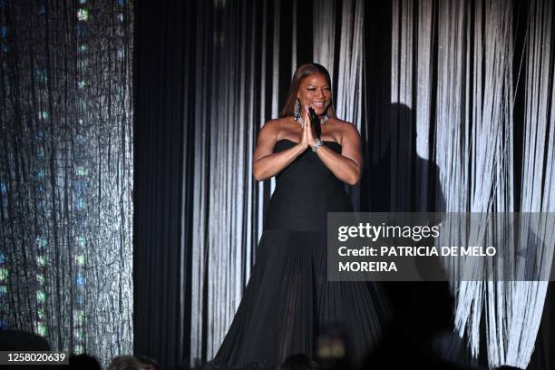 Rapper Queen Latifah arrives on stage during the annual amfAR Cinema Against AIDS Cannes Gala at the Hotel du Cap-Eden-Roc in Cap d'Antibes, southern...