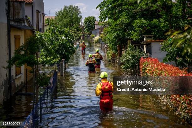 Special operators of the Italian Red Cross and firefighters rescuers seek and help residents blocked in their homes after heavy rains caused flooding...