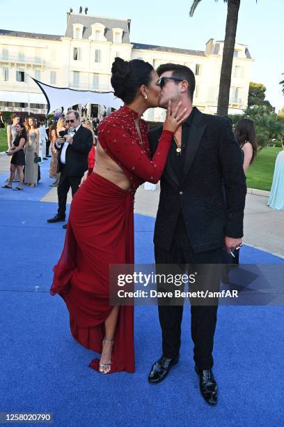 April Love Geary and Robin Thicke attend the amfAR Cannes Gala 2023 at Hotel du Cap-Eden-Roc on May 25, 2023 in Cap d'Antibes, France.