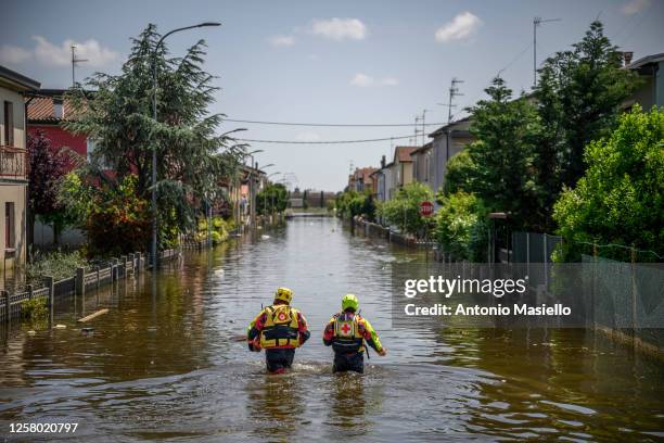 Special operators of the Italian Red Cross and firefighters rescuers seek and help residents blocked in their homes after heavy rains caused flooding...