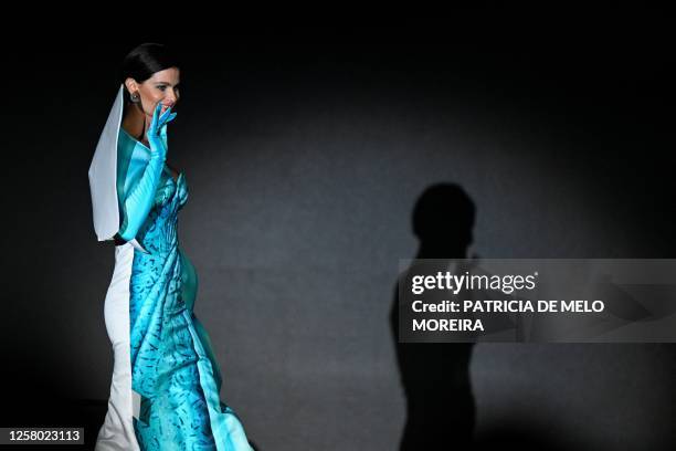 Brazilian model Isabeli Fontana presents an outfit on stage during the annual amfAR Cinema Against AIDS Cannes Gala at the Hotel du Cap-Eden-Roc in...