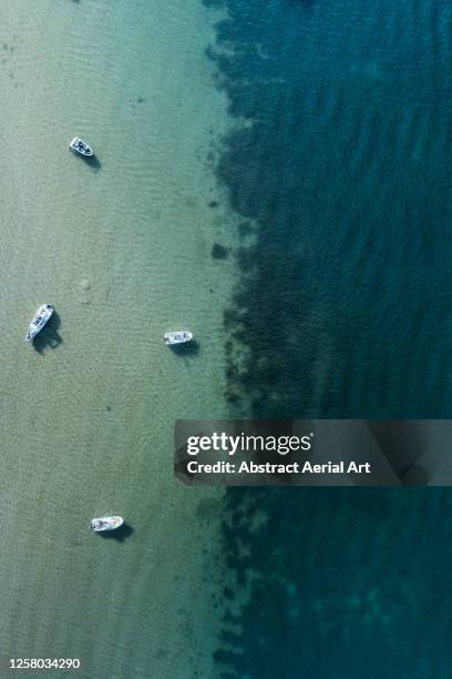 moored boats in shallow water seen from directly above, dorset, england, united kingdom - jurassic coast world heritage site 個照片及圖片檔