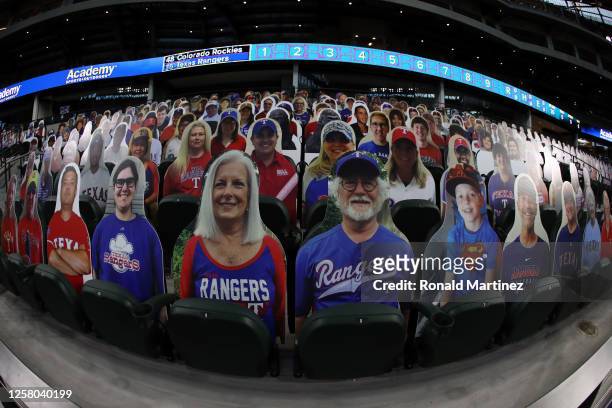 Cardboard cut-out images of fans are seen in the stands before a game between the Colorado Rockies and the Texas Rangers on Opening Day at Globe Life...